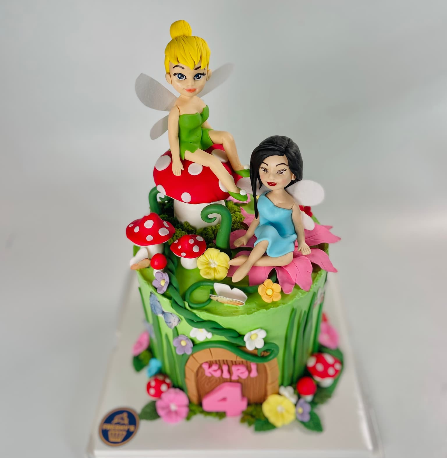 100% edible fondant sculpted Tinkerbell in forest sitting on a mushroom