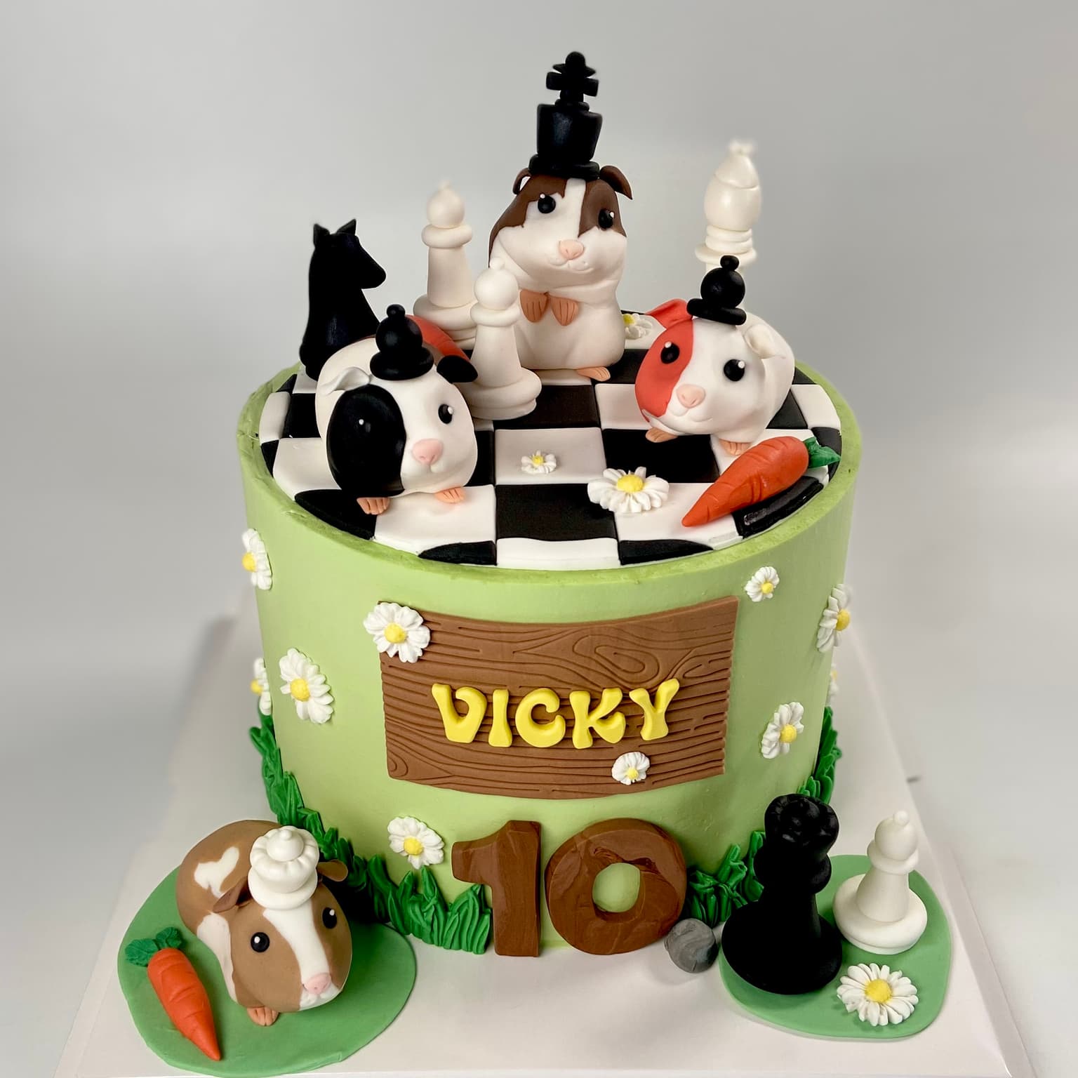 100% edible fondant sculpted hamsters on a chess board playing chess