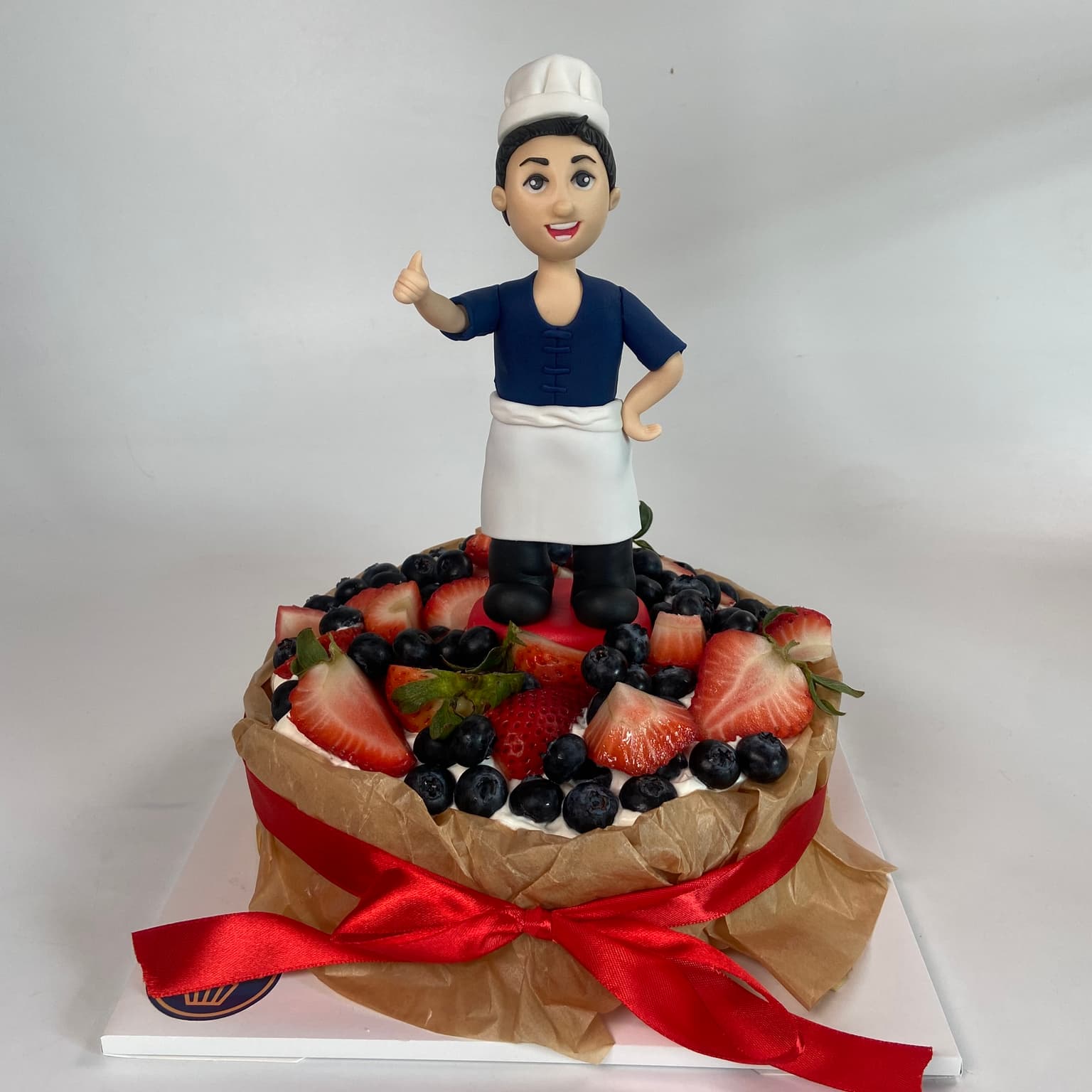100% edible fondant sculpted custom chef character on cheesecake