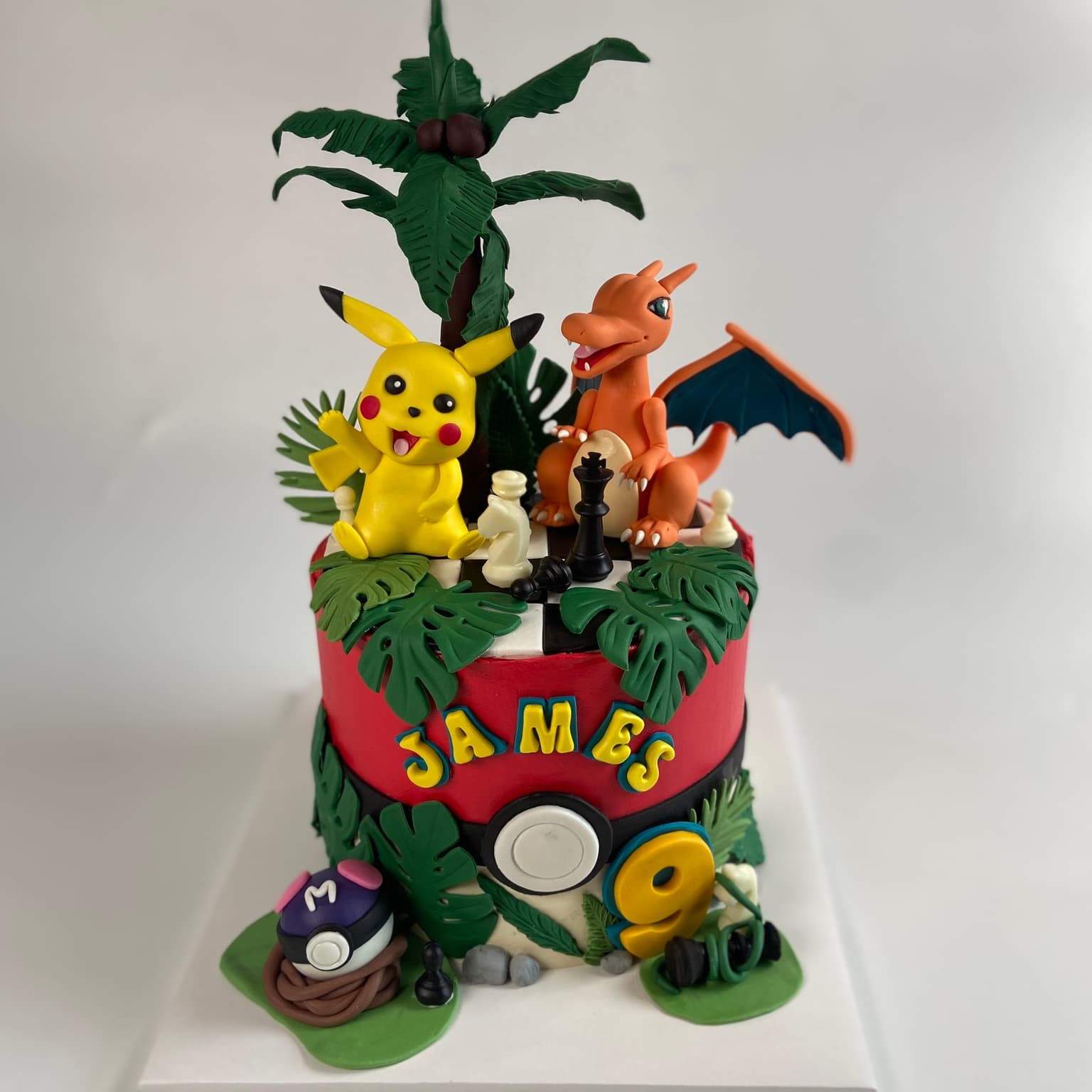 100% edible fondant sculpted Pokemin Pickachu and Charazrd on Pokeball