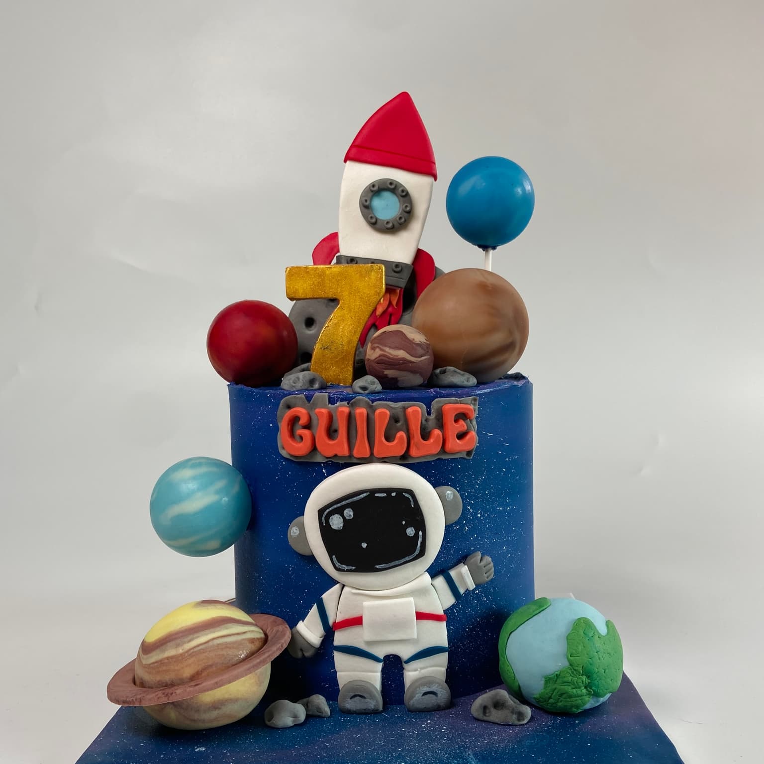 100% edible fondant sculpted astronaught with kids rocket and planets scene