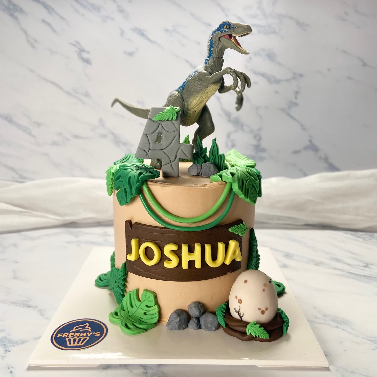 Fondant sculpted dinosaur cake