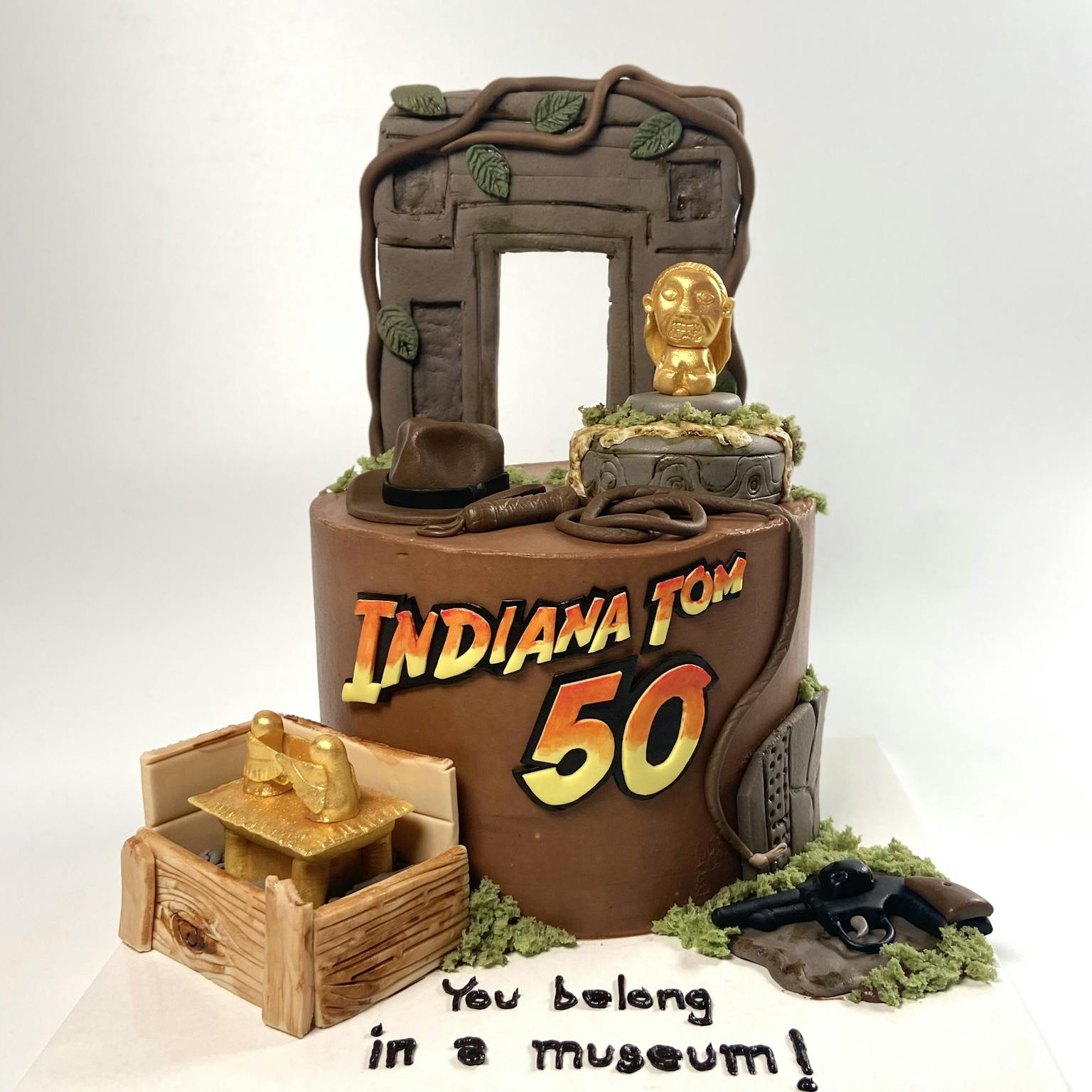 100% edible fondant sculpted Indiana Jones themed birthdy cake with idol, whip, hat and Arc of the Covenant
